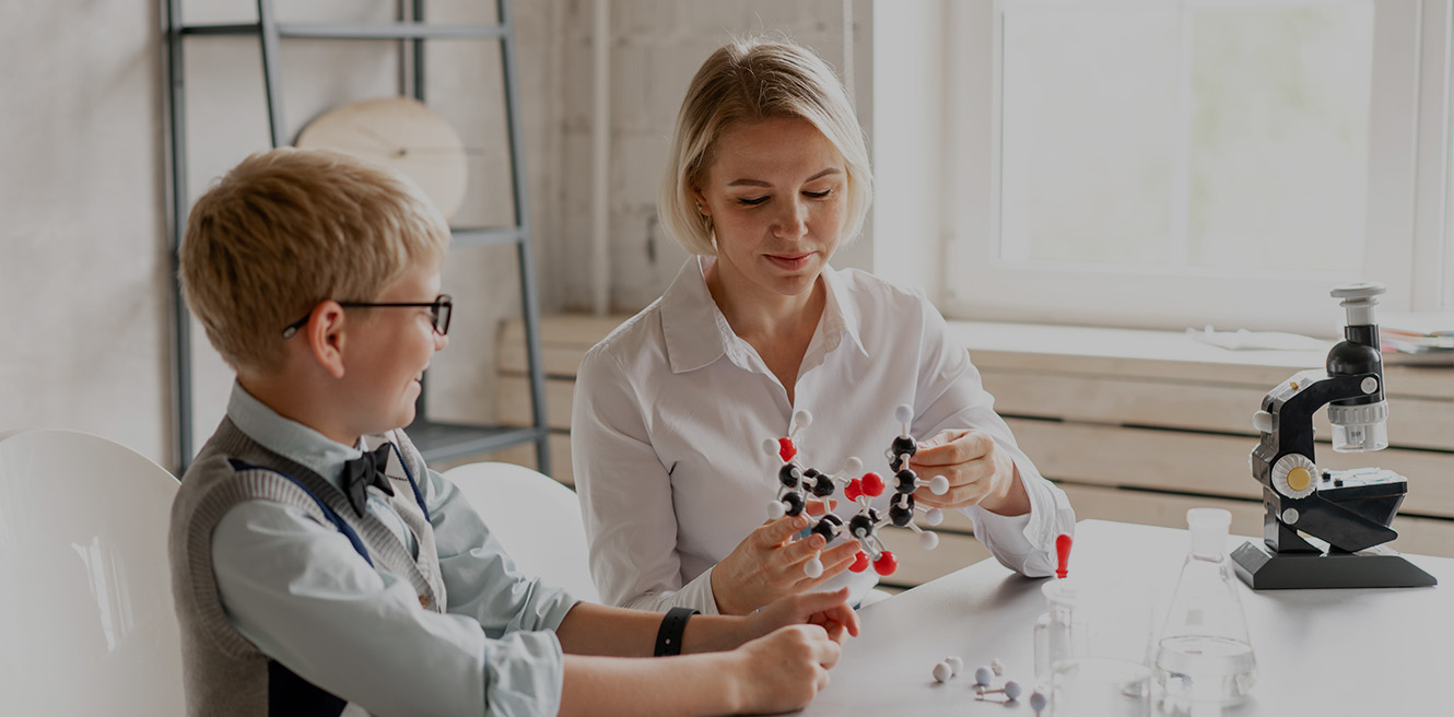 Female science tutor in Columbus studying chemistry with student